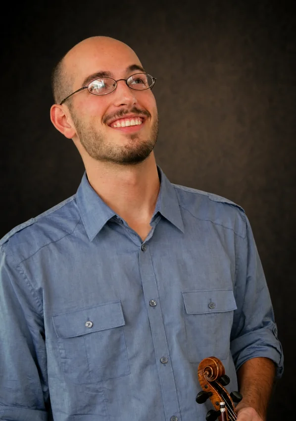 Trae McMaken holding a fiddle